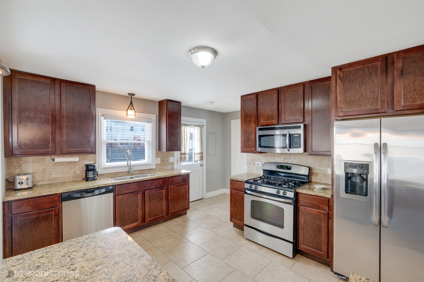 1415 South Chestnut Drive Mount Prospect, IL 60056 - Photo 7 of 15 a kitchen with stainless steel appliances granite countertop a stove a sink dishwasher a refrigerator and cabinets with wooden floor
