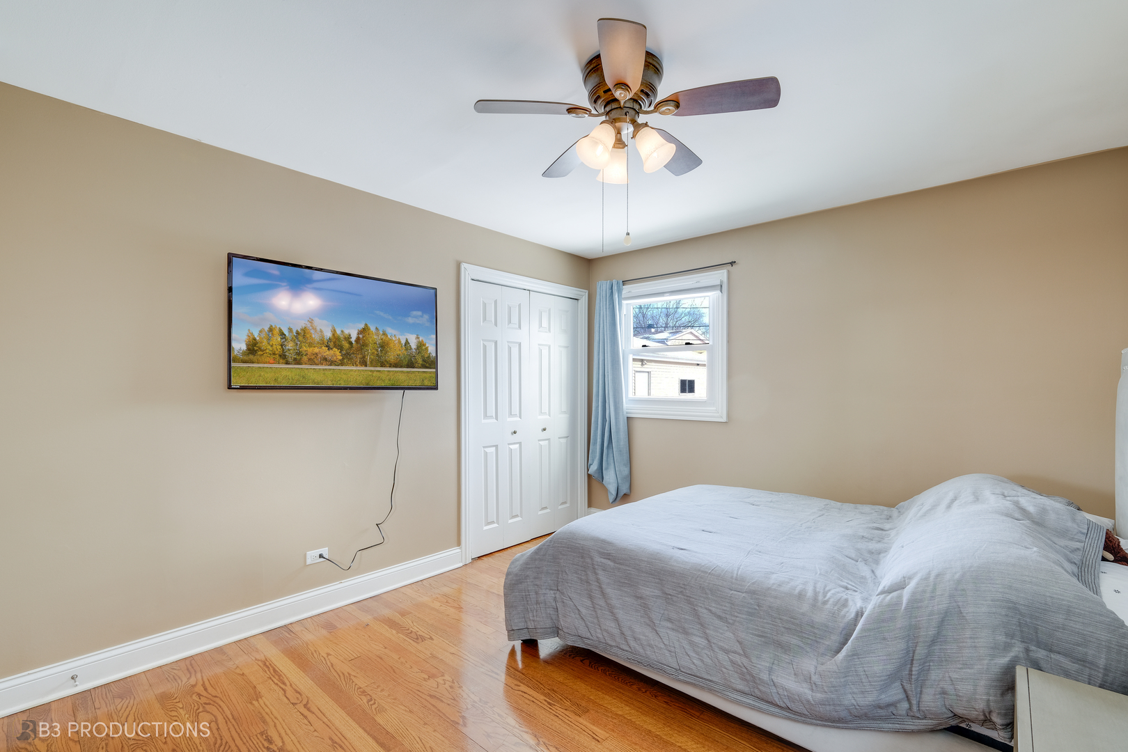 1415 South Chestnut Drive Mount Prospect, IL 60056 - Photo 9 of 15 a bedroom with a large bed and a chandelier