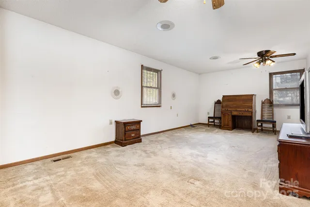 a view of a house with pool and a yard