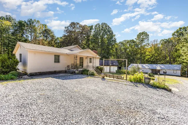 a swimming pool with yard in front of it