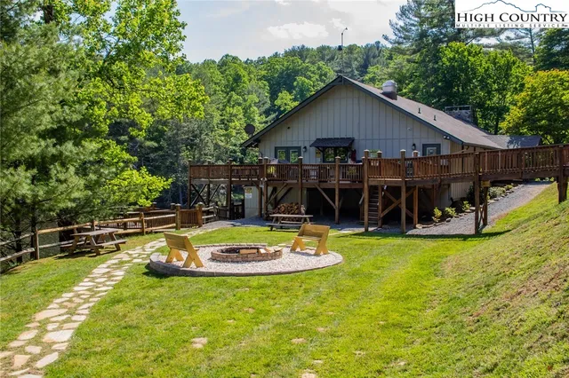 a view of a house with swimming pool and a yard