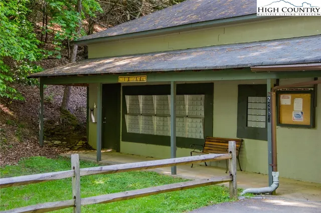 a view of brick house with a large window and a yard