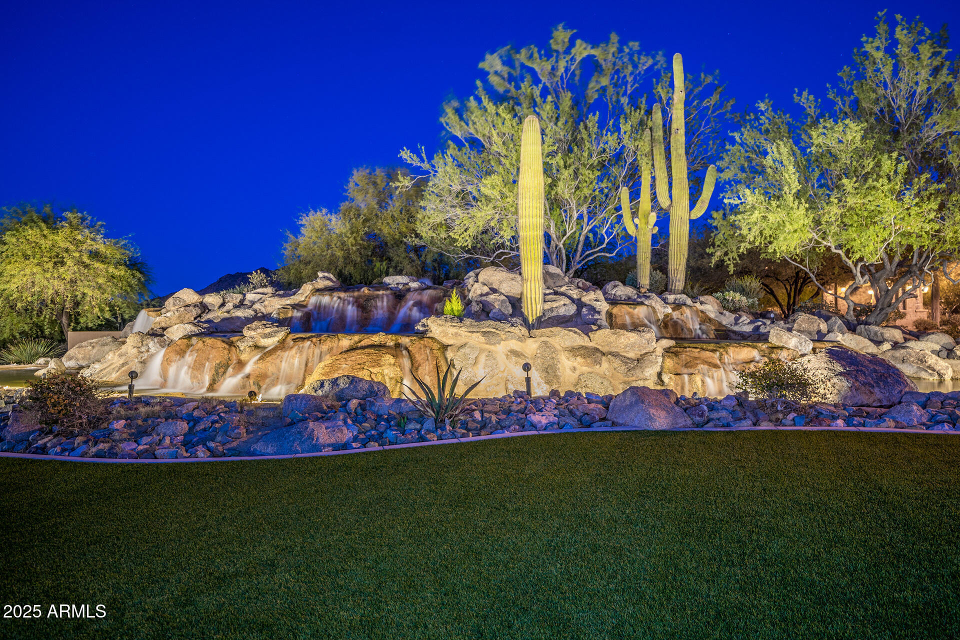 4037 North Pinnacle Hills Circle Mesa, AZ 85207 - Photo 105 of 195 a view of a backyard with plants and palm trees