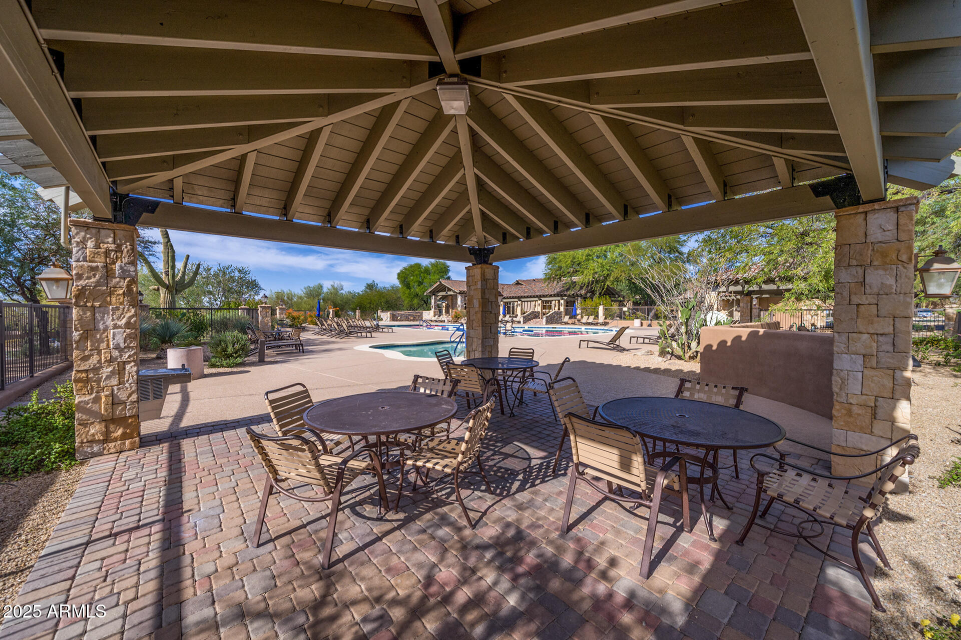 4037 North Pinnacle Hills Circle Mesa, AZ 85207 - Photo 186 of 195 a view of patio with table and chairs under an umbrella with a small yard
