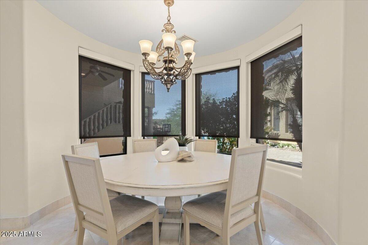 4037 North Pinnacle Hills Circle Mesa, AZ 85207 - Photo 28 of 195 a view of a dining room with furniture large windows and wooden floor