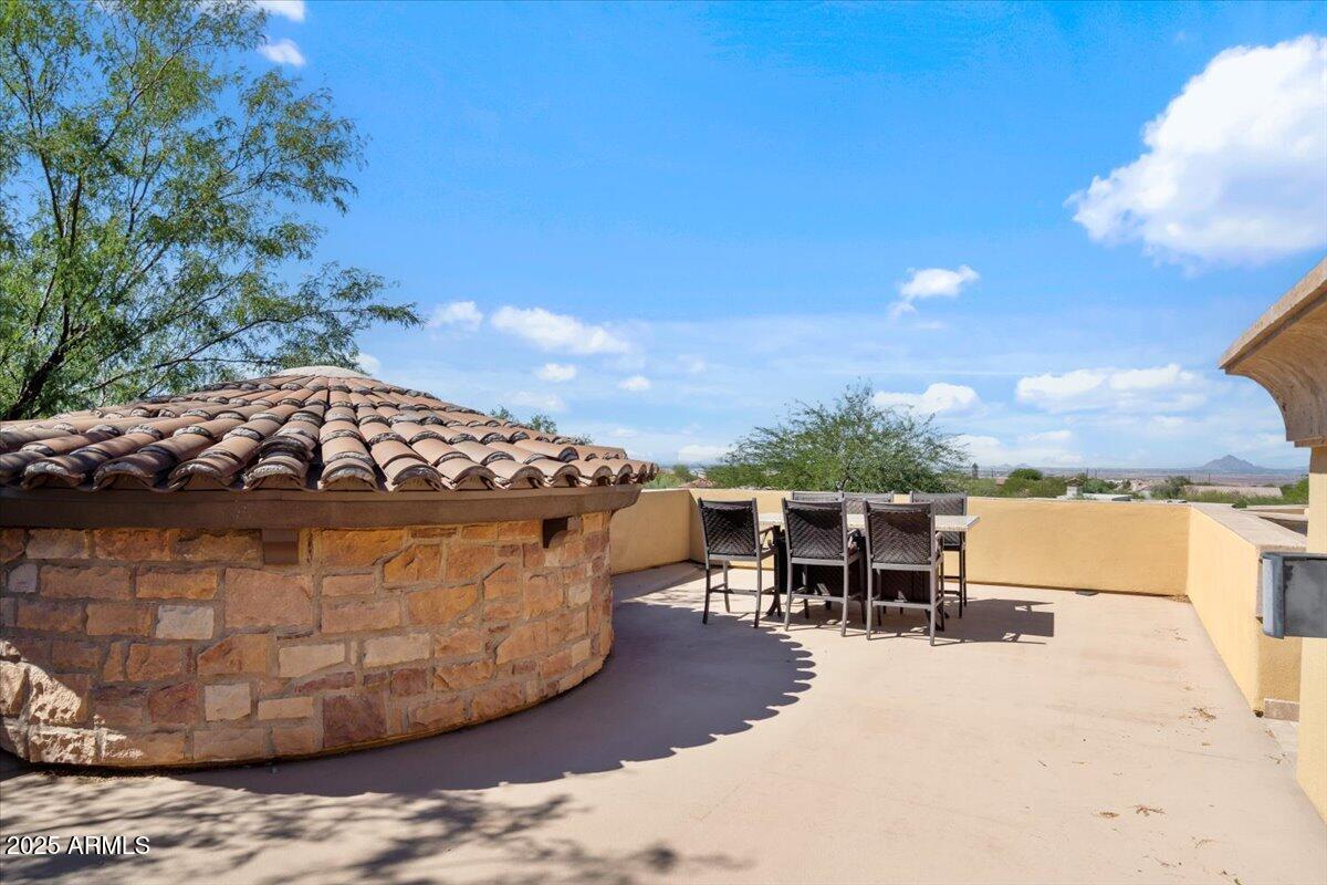 4037 North Pinnacle Hills Circle Mesa, AZ 85207 - Photo 63 of 195 a view of a chairs and table in the backyard