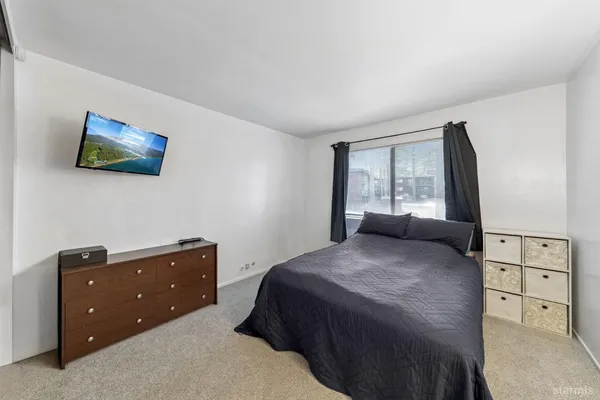 a bedroom with a bed and a window