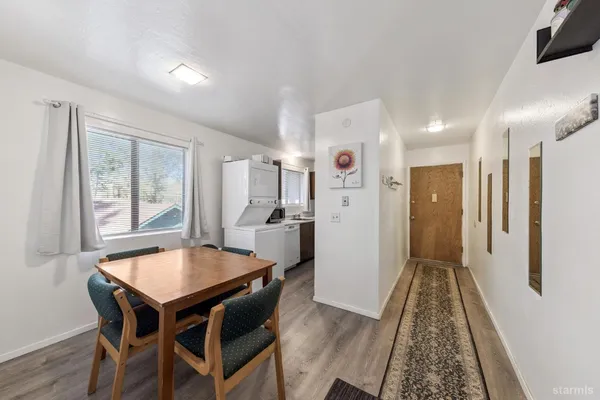 a view of a dining room with furniture and wooden floor