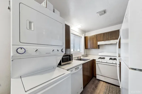 a view of washer and dryer with kitchen in the background