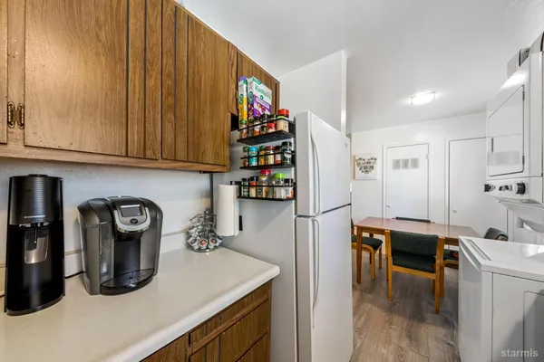 a room with stainless steel appliances granite countertop a refrigerator and a sink