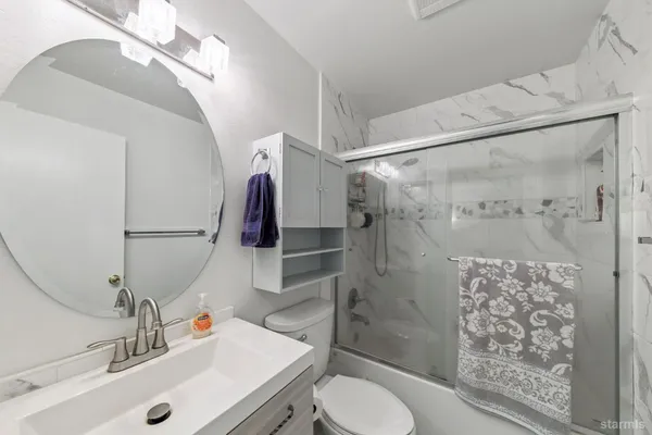 a bathroom with a sink toilet and shower