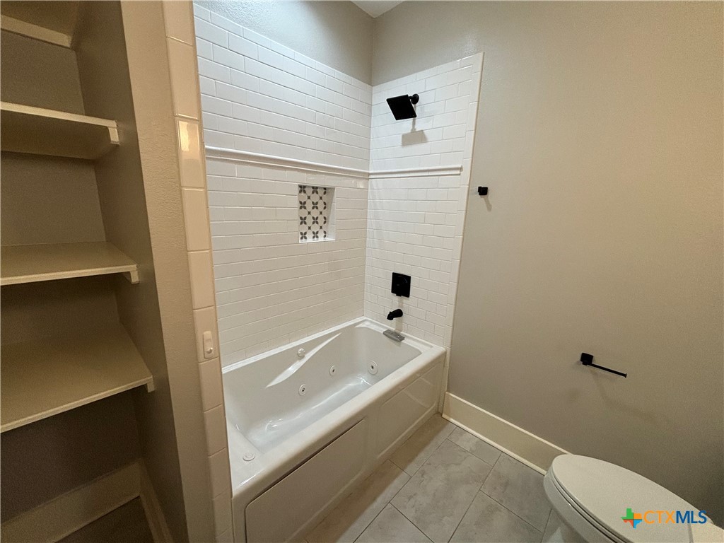 110 Hiram Cook Blanco, TX 78606 - Photo 20 of 46 a bathroom with a bathtub and toilet
