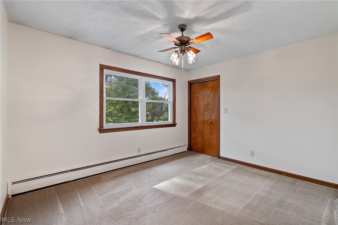 34 Kehner Road Mogadore, OH 44260 - Photo 24 of 40 Neutral-toned carpeting, white walls, and a multi-pane window with wood trim