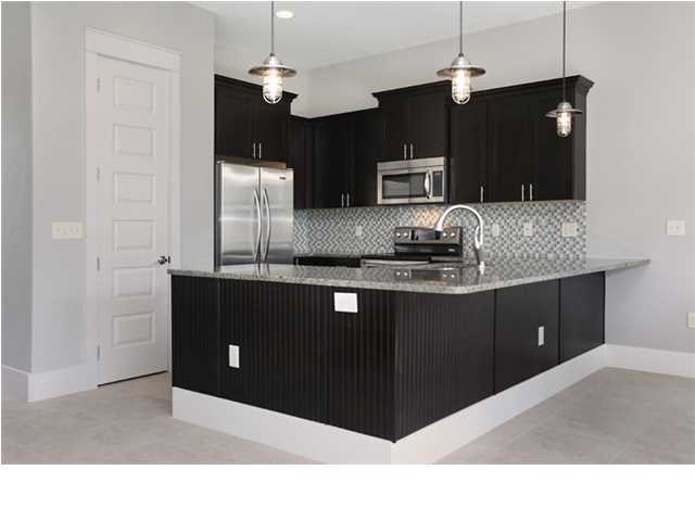 228 Miami Street Miramar Beach, FL 32550 - Photo 16 of 32 a kitchen with cabinets and stainless steel appliances