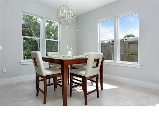 228 Miami Street Miramar Beach, FL 32550 - Photo 9 of 32 a dining room with furniture a rug a potted plant and a chandelier