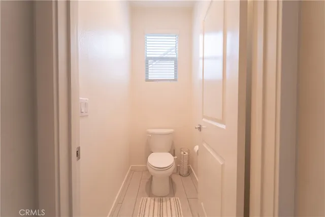 a bathroom with a toilet and a window