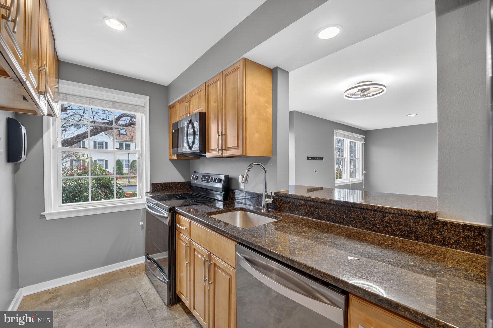 2248 Washington Avenue, Unit 101 Silver Spring, MD 20910 - Photo 15 of 23 a kitchen with stainless steel appliances granite countertop a sink a stove a counter space and cabinets
