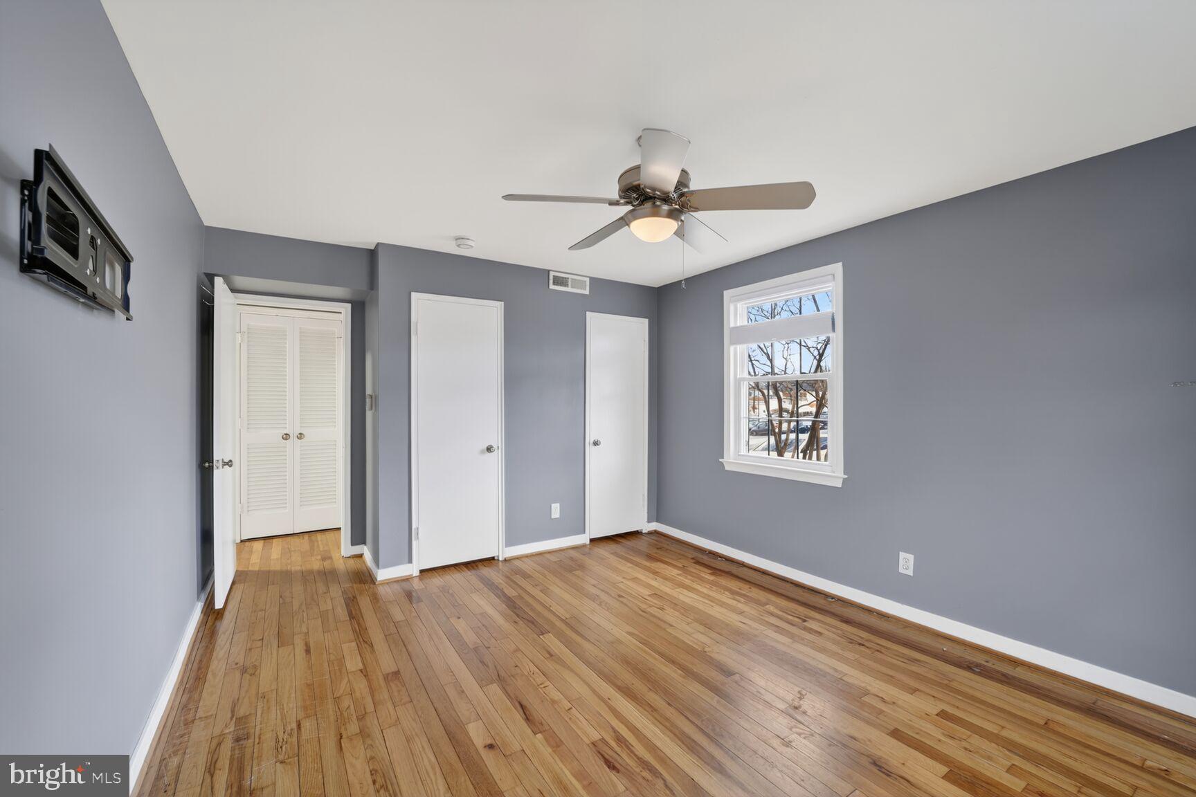 2248 Washington Avenue, Unit 101 Silver Spring, MD 20910 - Photo 22 of 23 a view of an empty room with window and wooden floor