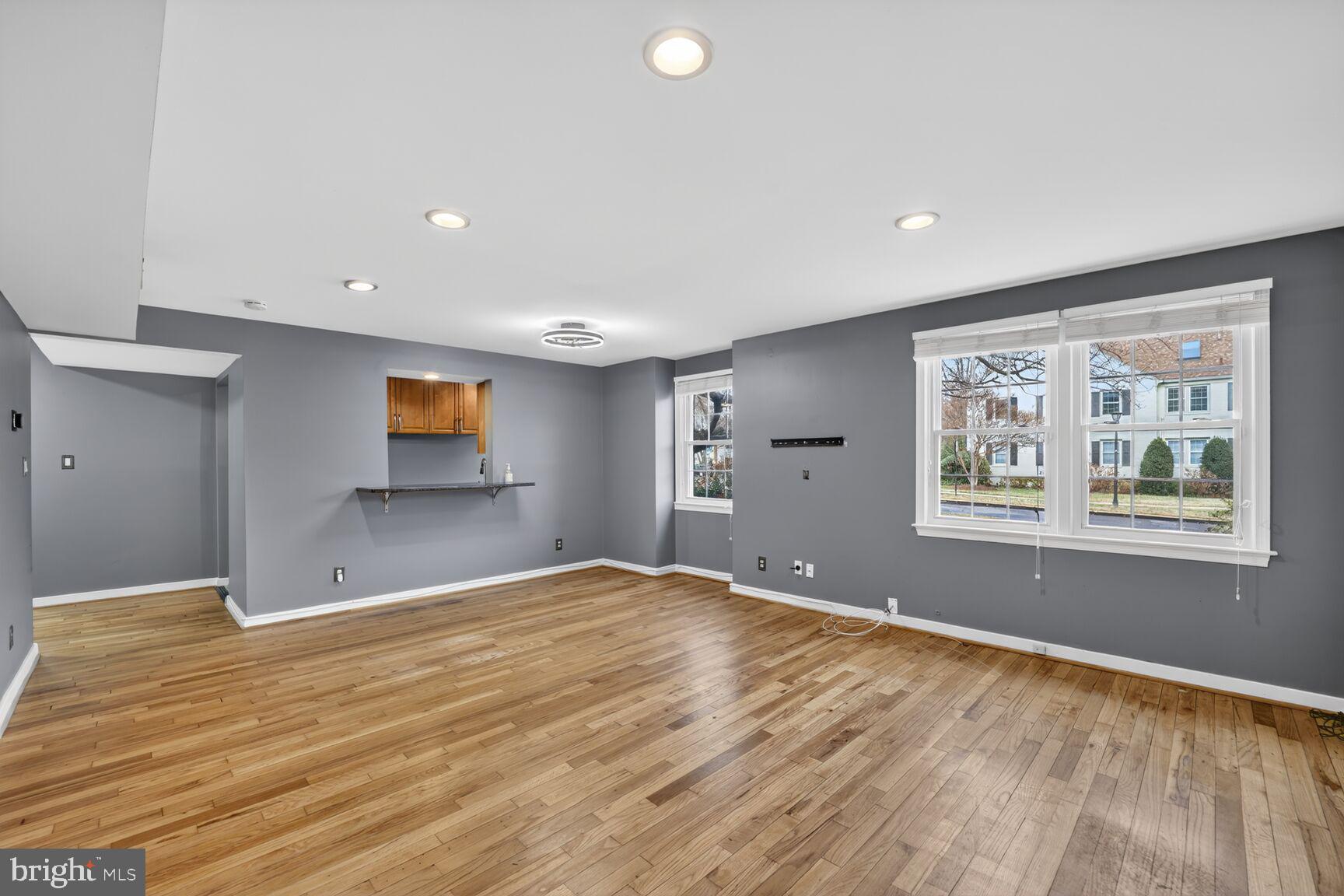 2248 Washington Avenue, Unit 101 Silver Spring, MD 20910 - Photo 6 of 23 a view of an empty room with window and wooden floor