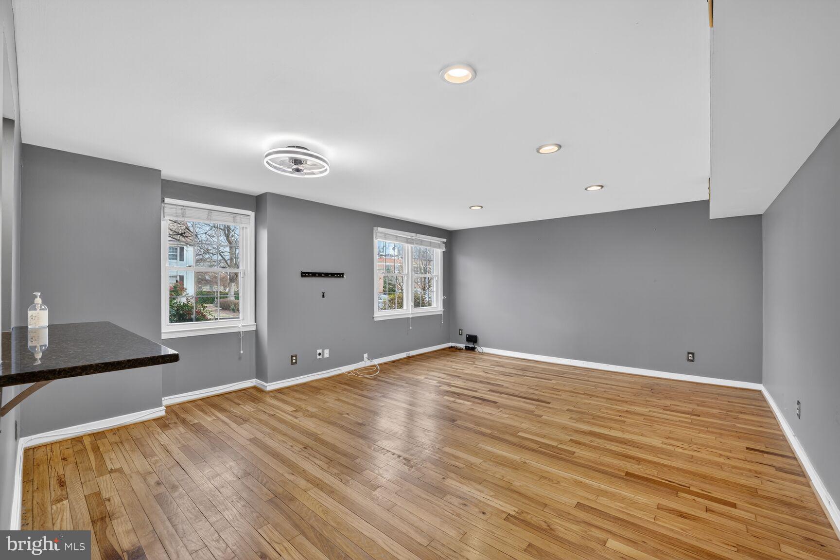 2248 Washington Avenue, Unit 101 Silver Spring, MD 20910 - Photo 10 of 23 a view of an empty room with wooden floor and a window