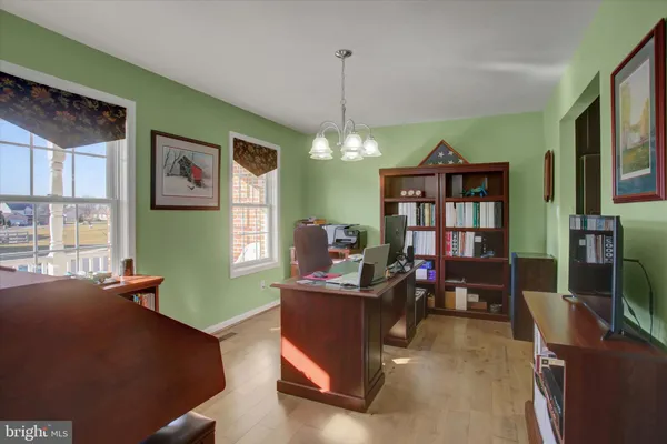 a living room with furniture and a book shelf