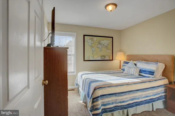 a bedroom with a bed and a lamp on table