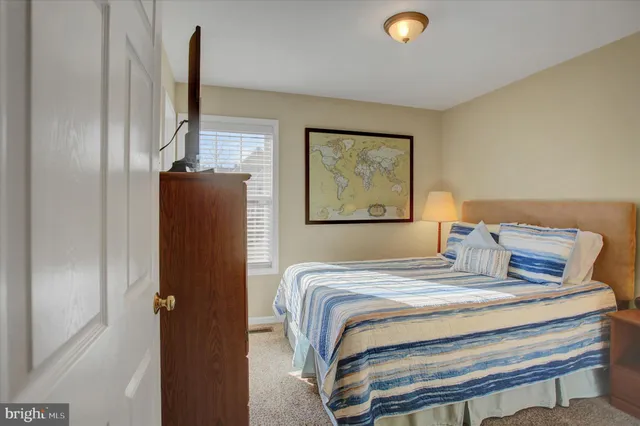 a bedroom with a bed and a lamp on table