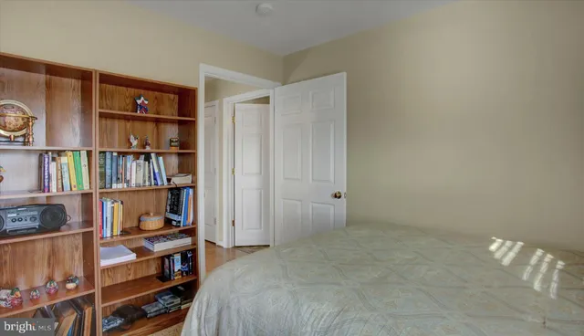 a bedroom with a bed and a book shelf