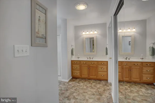 a bathroom with a granite countertop sink mirror and a