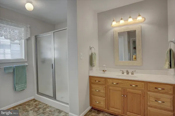 a bathroom with a double vanity sink and mirror with shower