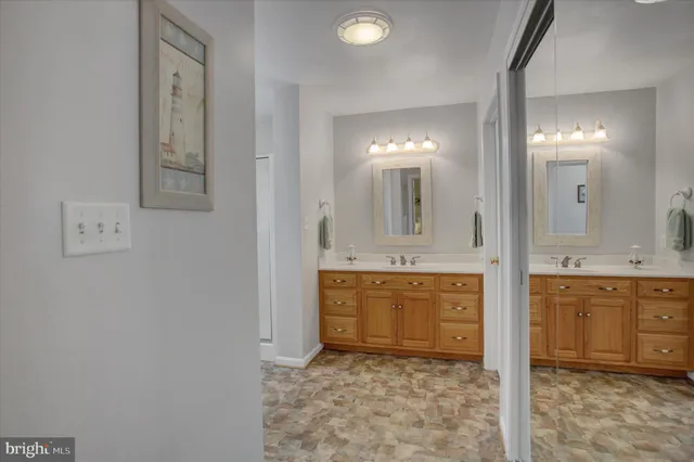 a bathroom with a granite countertop sink mirror and a