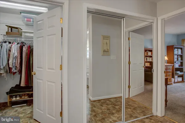 a view of walk in closet with clothes