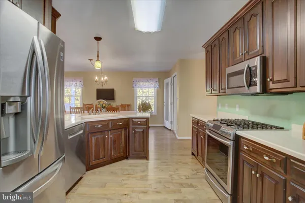 a kitchen with stainless steel appliances granite countertop a refrigerator and a sink
