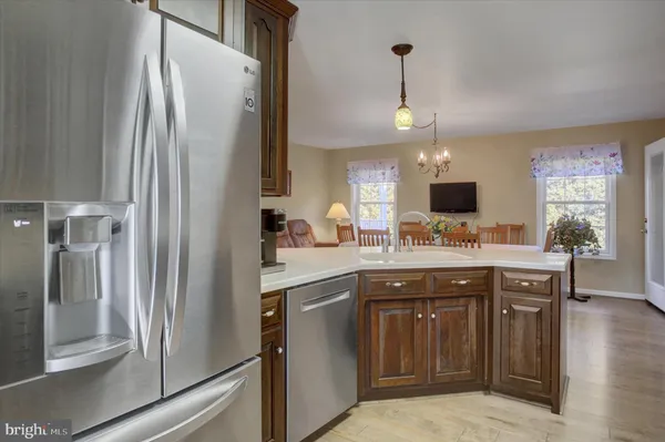 a kitchen with wooden cabinets and a stove top oven