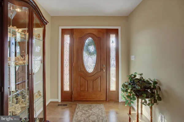 a front view of a house with a potted plant