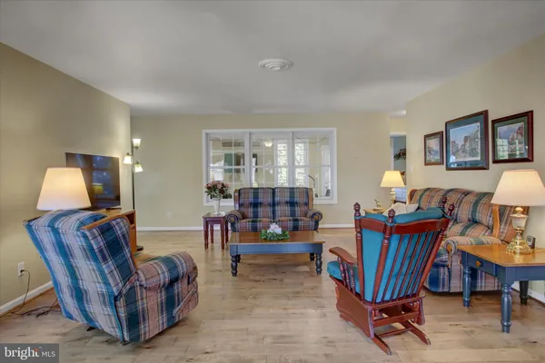 a living room with furniture and a lamp
