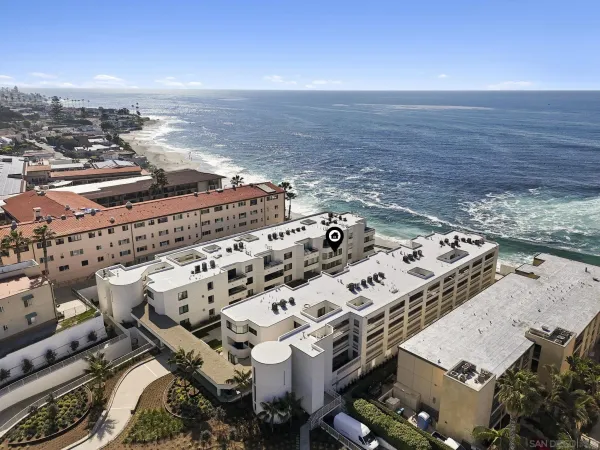 an aerial view of a building with ocean view