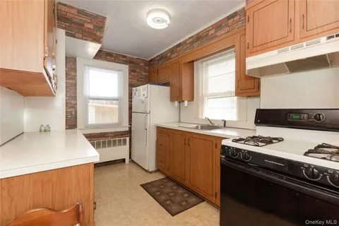 a kitchen with stainless steel appliances a stove a sink and a refrigerator