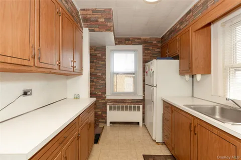 a kitchen with a refrigerator sink and cabinets