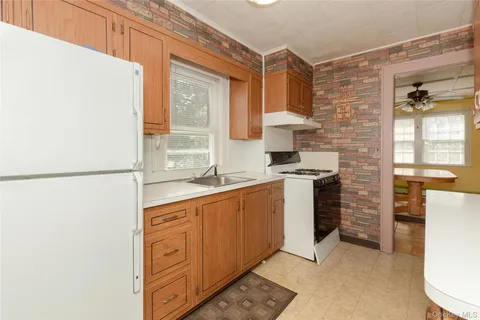 a kitchen with a refrigerator and a stove