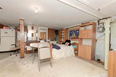 a living room with furniture a window and gym equipment