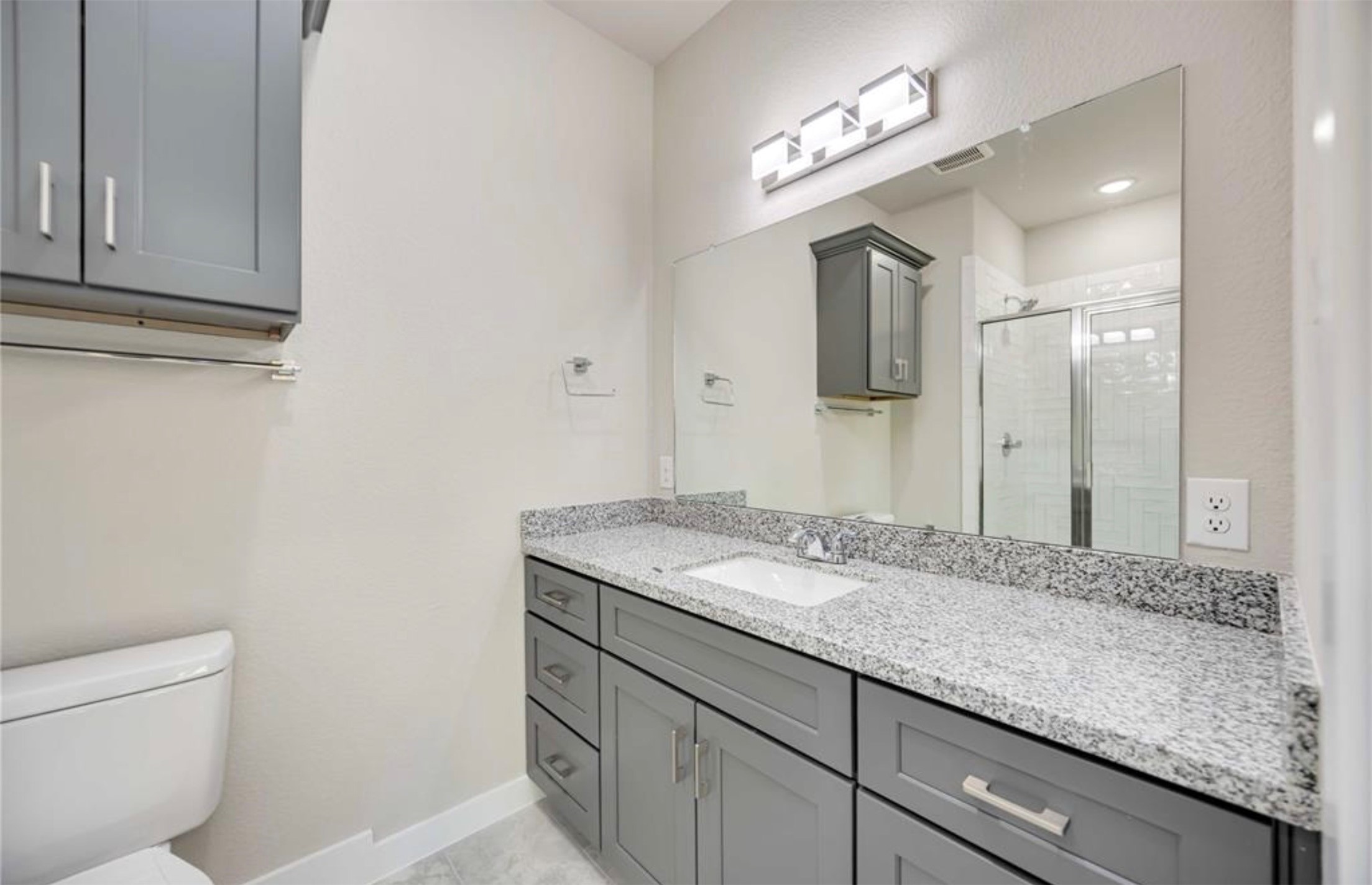 415 Gans Street, Unit AB Houston, TX 77029 - Photo 15 of 24 a bathroom with a granite countertop sink and a mirror