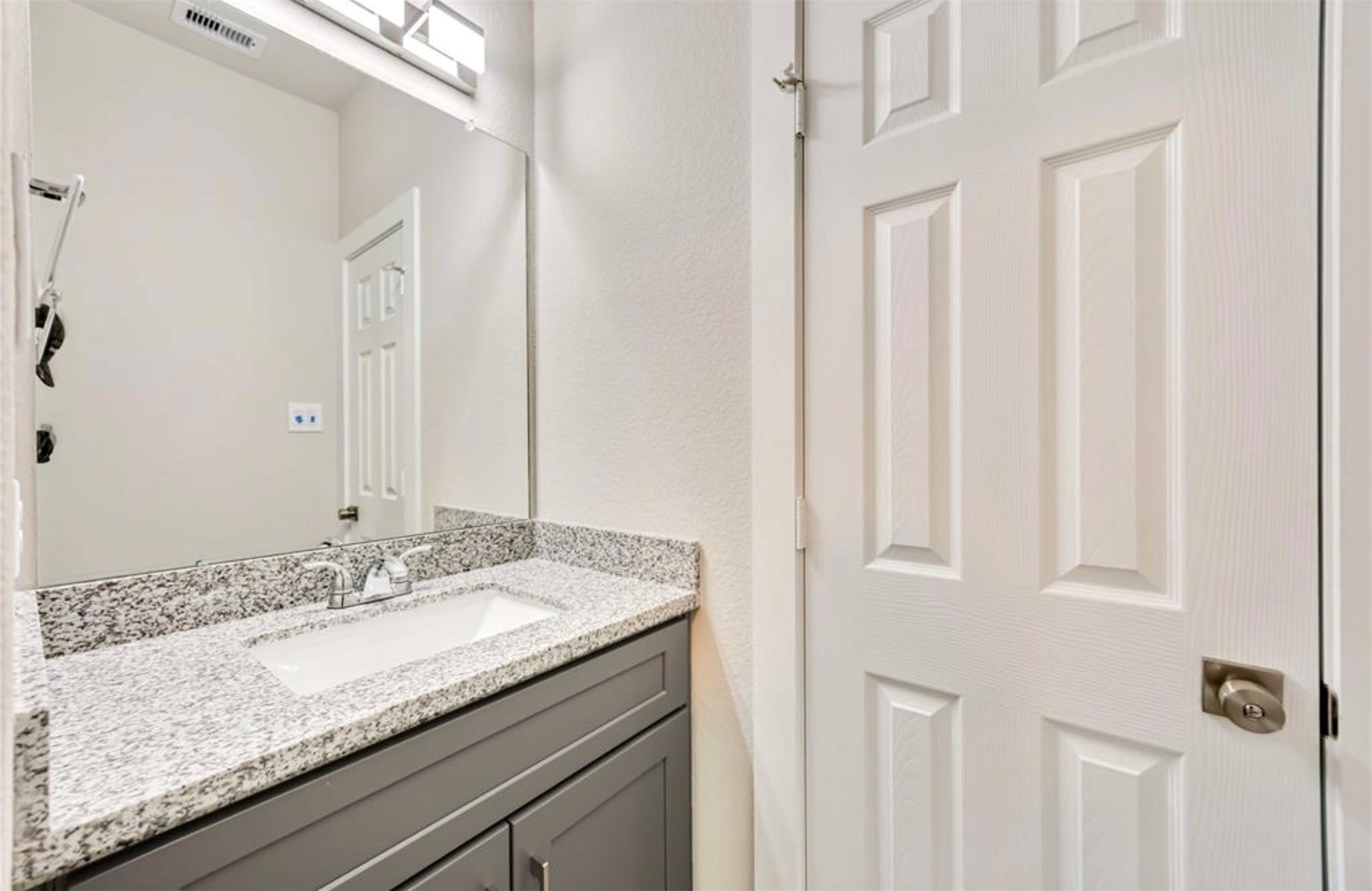 415 Gans Street, Unit AB Houston, TX 77029 - Photo 21 of 24 a bathroom with a granite countertop sink and a mirror