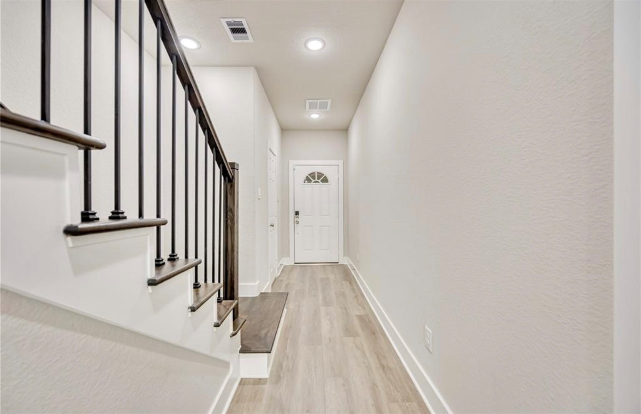 415 Gans Street, Unit AB Houston, TX 77029 - Photo 3 of 24 a view of a hallway with wooden floor and staircase