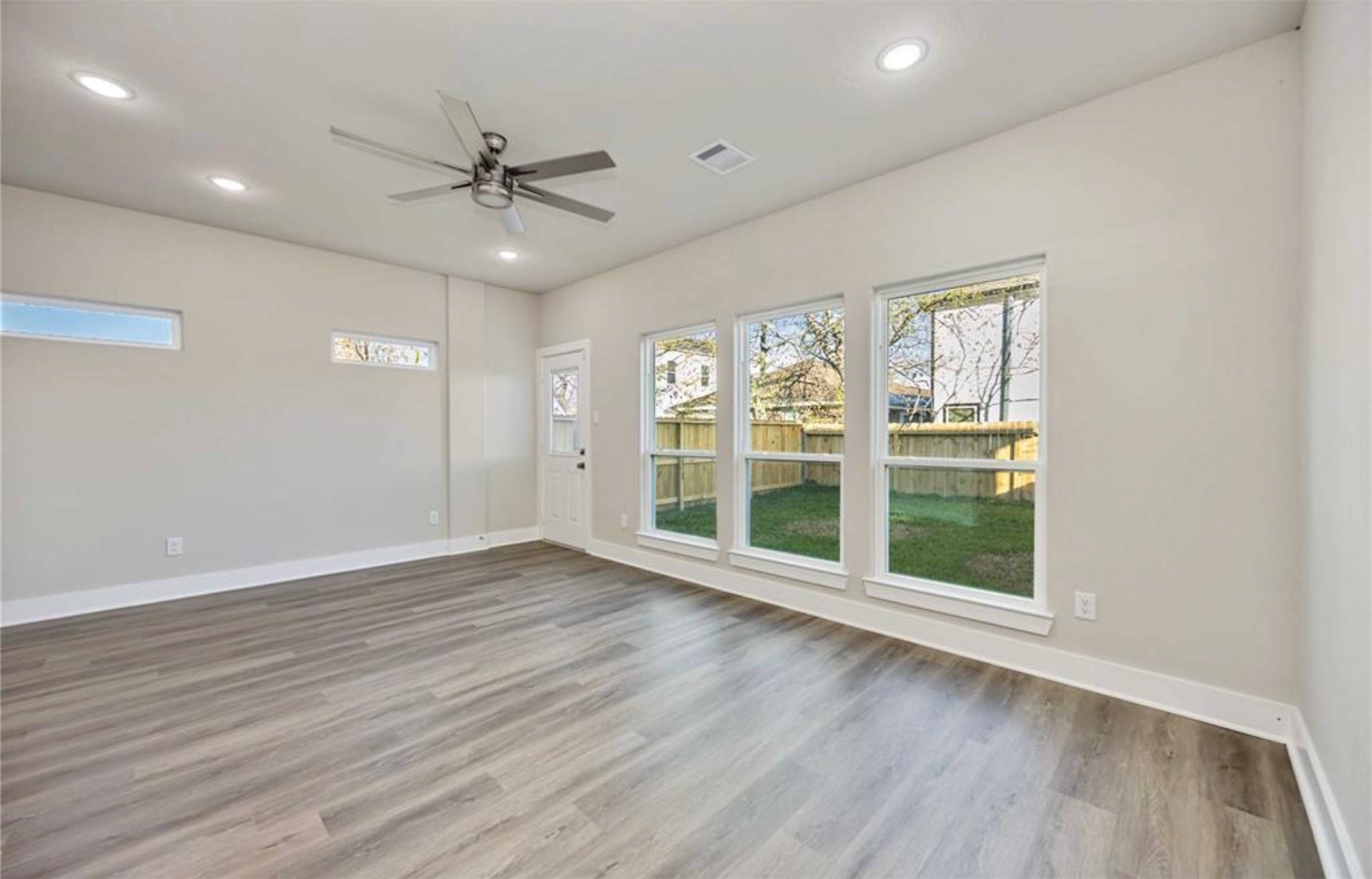 415 Gans Street, Unit AB Houston, TX 77029 - Photo 10 of 24 a view of an empty room with a window and wooden floor