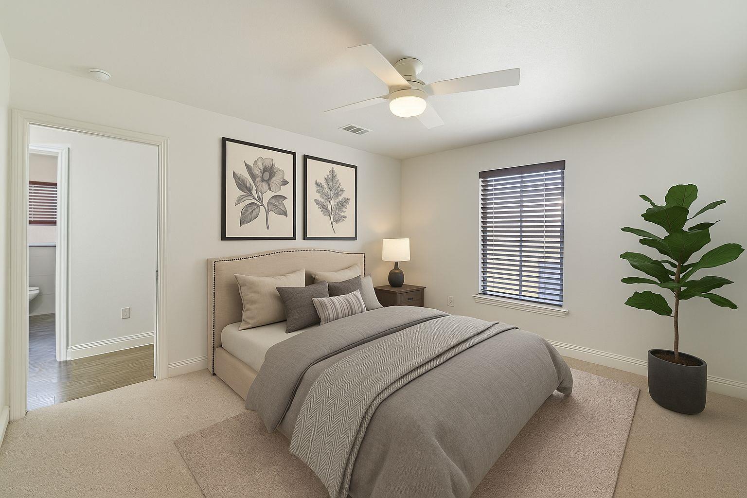 3705 Manorwood Road Austin, TX 78723 - Photo 8 of 13 a bedroom with a large bed and a potted plant