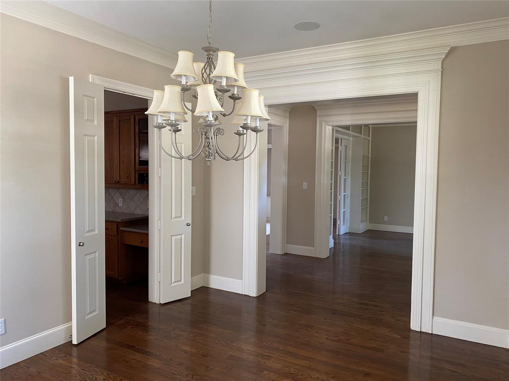 2605 Tulip Drive Richardson, TX 75082 - Photo 8 of 30 a view of a hallway with wooden floor and chandelier