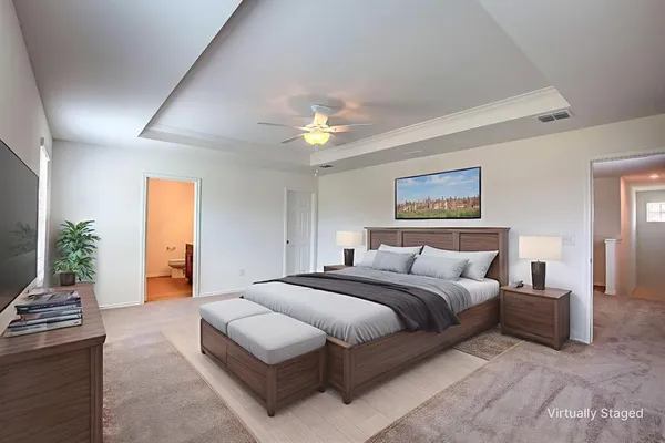 a spacious bedroom with a bed and a chandelier