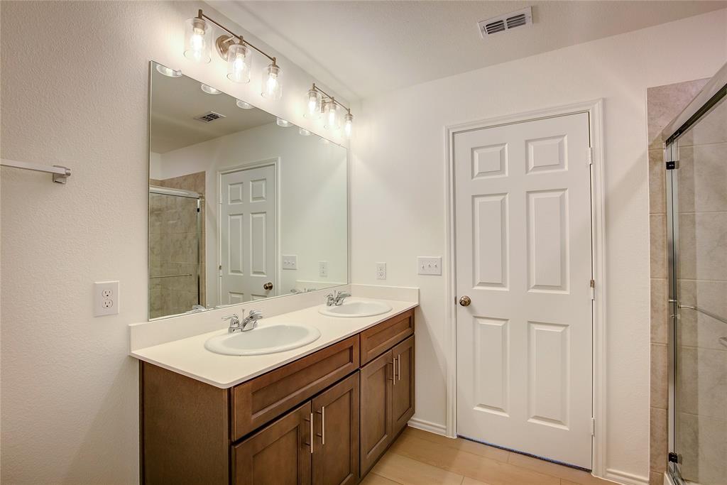 1426 Tramore Way Princeton, TX 75407 - Photo 13 of 20 a bathroom with a sink and a mirror