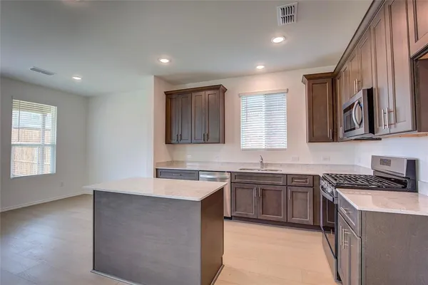 a kitchen with a sink stove and cabinets